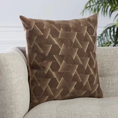 a brown pillow sitting on top of a couch