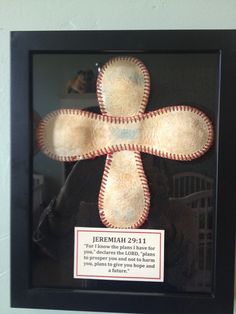 a framed baseball bat in a black frame with a plaque on the wall behind it