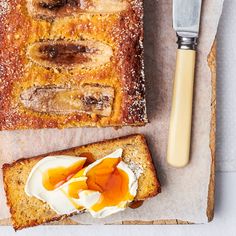 two slices of bread with an egg and butter spread on them next to a knife