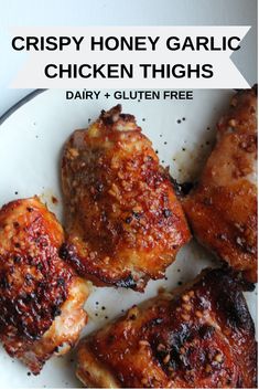 crispy honey garlic chicken thighs on a white plate with text overlay that reads crispy honey garlic chicken thighs dairy + gluten free