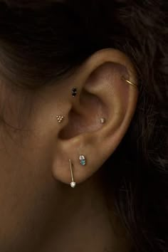 a woman with three piercings on her ear