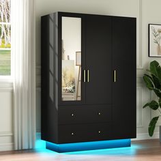 a tall black cabinet with blue lights on the bottom and side doors, in front of a potted plant