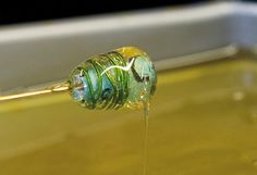 a liquid pouring from a pipe into a container