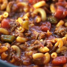 a close up view of some pasta and meat in a bowl with sauce on top