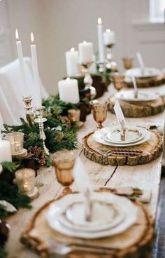 the table is set with candles and plates