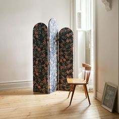 the room dividers are decorated with flowers and leaves, along with a wooden chair