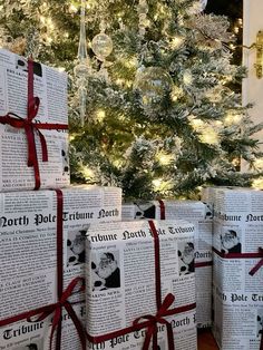 several wrapped presents sitting in front of a christmas tree