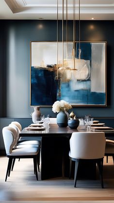 a dining room table with white chairs and a large painting on the wall behind it