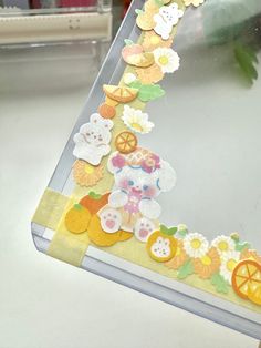 a close up of a cell phone case with flowers and fruits on the back side