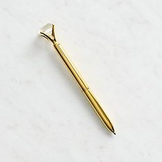 a gold toothbrush sitting on top of a white counter