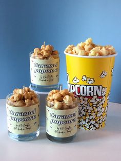 three cups filled with popcorn sitting next to each other