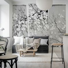 the living room is decorated with black and white wallpaper, including an abstract tree mural