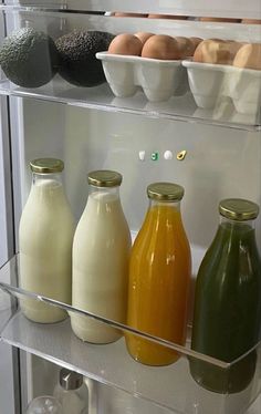 an open refrigerator filled with lots of different types of juices and condiments