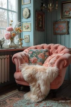 a pink chair sitting in front of a window