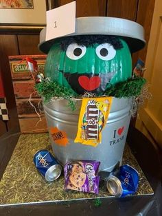 a bucket that has some candy in it and a face on the top of it