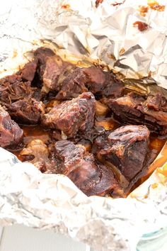 the meat is cooked in foil and ready to be eaten on the table for consumption