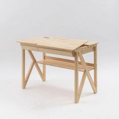 a wooden desk sitting on top of a white floor