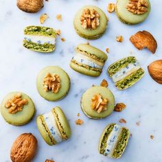 assorted macaroons and walnuts on a marble surface