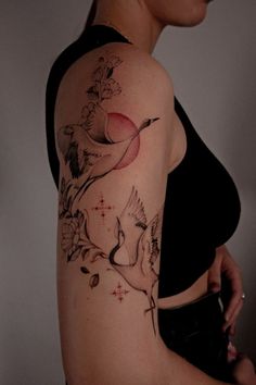 a woman with a bird tattoo on her arm