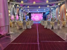 a banquet hall with tables and chairs set up for an event