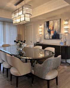 a dining room table with chairs around it and a chandelier hanging from the ceiling