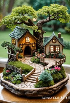 a miniature garden with a tree, house and stairs