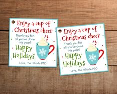 two christmas greeting cards with coffee cups on the front and back, sitting on a wooden surface