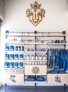 the inside of a clothing store with shelves and drawers