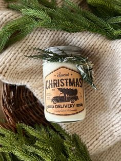 a jar filled with christmas candles sitting on top of a blanket