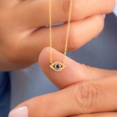 14k Gold and diamond evil eye necklace with sapphire, ruby and emerald center stone options. Diamond: 0.10 ct diamond Charm Measurements: 10 mm x 5 mm ( 0.4 inch. x 0.5 inch ) Chain: 1.1 mm link chain Chain length: 14+2 or 16+2 inch options ( Please let us know if you want a different length) Color: G Quality: SI-VS Additional Notes: * Non-Conflict Diamonds * Made in the USA C U R R E N T ∙ T U R N A R O U N D Processing Time: 1-2 weeks Within United States: approx. 3-5 biz days (faster shipping 14k Gold Evil Eye Jewelry Gift, Sapphire Diamond Necklace As A Fine Jewelry Gift, Sapphire Diamond Pendant Necklace For Gift, Sapphire Diamond Necklace As A Gift, Sapphire Diamond Necklace Fine Jewelry Gift, Yellow Gold Eye Necklaces With Diamond Eyes, Sapphire Diamond Necklace For Gift, Spiritual Cubic Zirconia Gemstone Necklace, Spiritual Gemstone Necklace With Cubic Zirconia