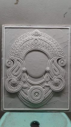 a white paper cutout with an intricate design