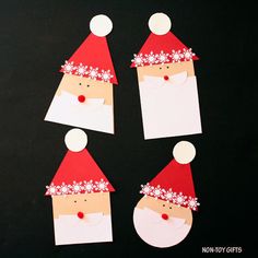 paper cut out of santa's head with flowers on it, sitting on a black surface