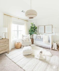 a baby's room with white furniture and decor