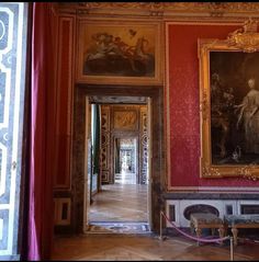 an ornate room with paintings on the walls