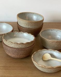 four bowls and a spoon on a table