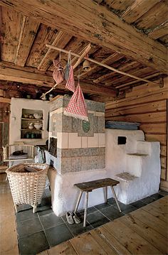 an old fashioned oven in the middle of a room with wood floors and ceilinging