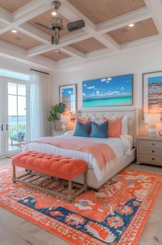 a bedroom with an orange and blue rug on the floor next to a large bed