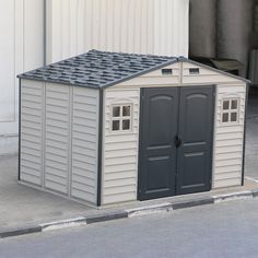 an outdoor storage shed with two doors on the side