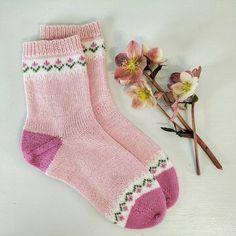 a pair of pink socks next to some flowers