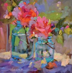 two jars with flowers in them sitting on a table