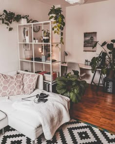 a living room filled with furniture and plants