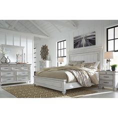 an image of a bedroom setting with white furniture