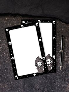 two notepads with skulls on them next to a pen