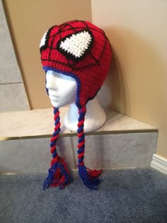 a crocheted spiderman hat on top of a mannequin head