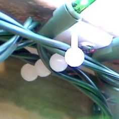 an electric cord connected to a device with a green and white light plugged into it