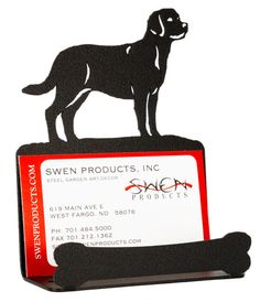 a dog is standing on top of a business card holder