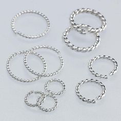 The braided look of this sterling silver round twist-wire jump ring adds texture and depth to designs. Use this ring to attach drops, dangles or charms or link it with other rings to build a chain; it is also a good choice for attaching a clasp. Jump rings are made from coiled wire and have an opening that allows you to insert it through a ring, loop or hole on another finding. A staple of the jewelry-making industry, these rings are ideal as attach rings for component designs, as strand or chai Jump Ring Jewelry, Jewelry Making Cord, Coupon Storage, Eternity Rings, Discount Illustration, Kim Deal, Coupon Spreadsheet, Coupon Design, Coupon Organization