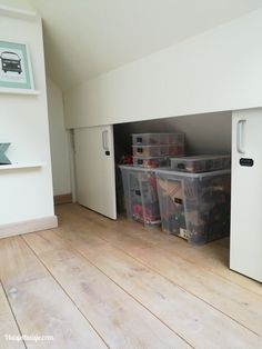 an empty room with several storage bins in it