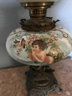 an antique lamp with a cherub on it