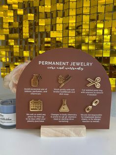 the permanent jewelry display is displayed on a table next to a jar of paint and scissors